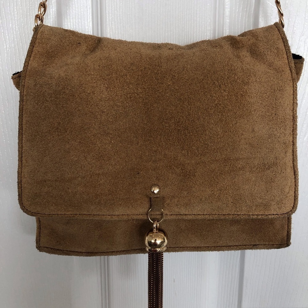 Suede chain strap bag flap closure metal tassel detail. Tan color.
